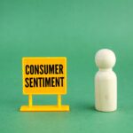 yellow signs and wooden figures with the words Consumer Sentiment